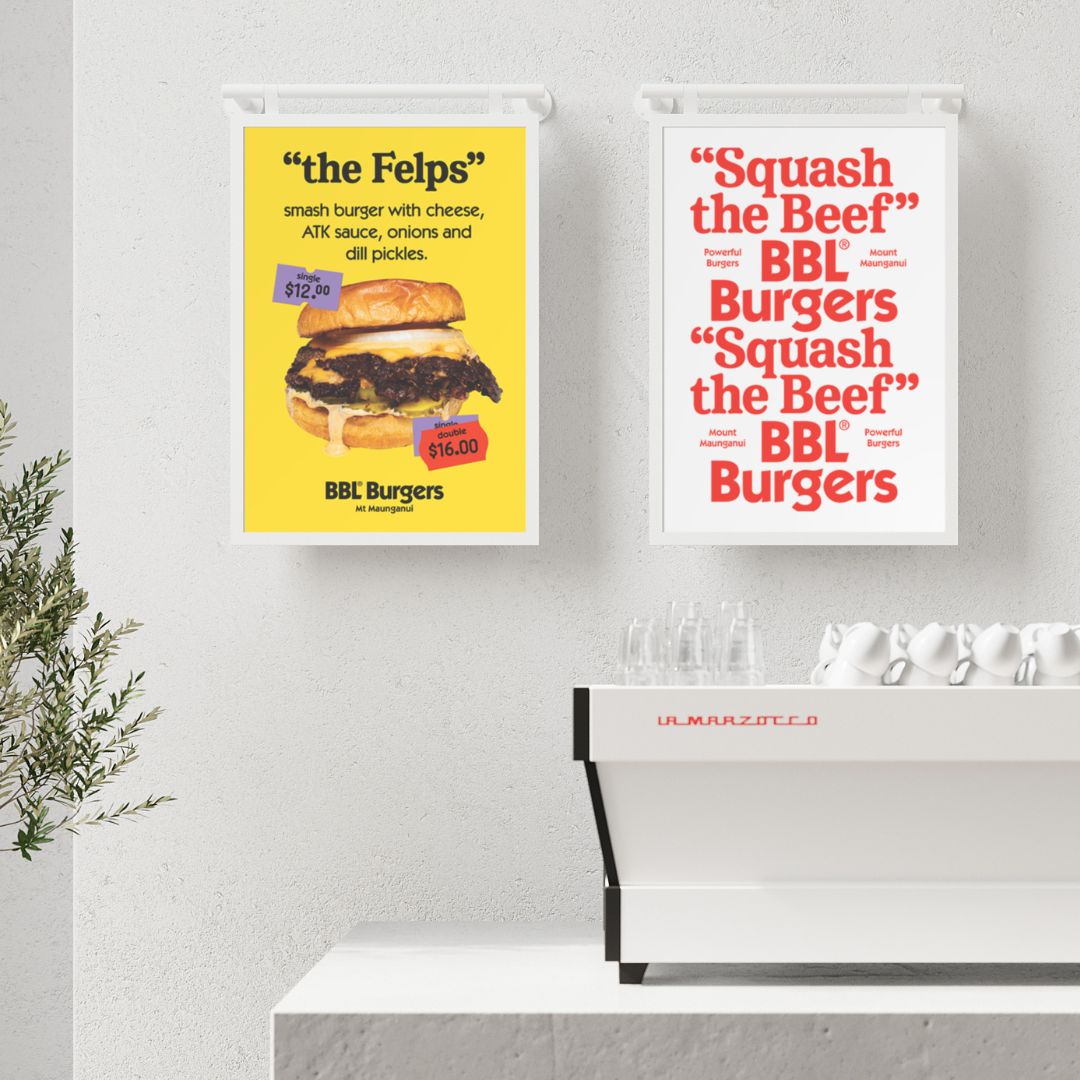 two white poster hanging menu boards side by side behind countertop displaying burger specials