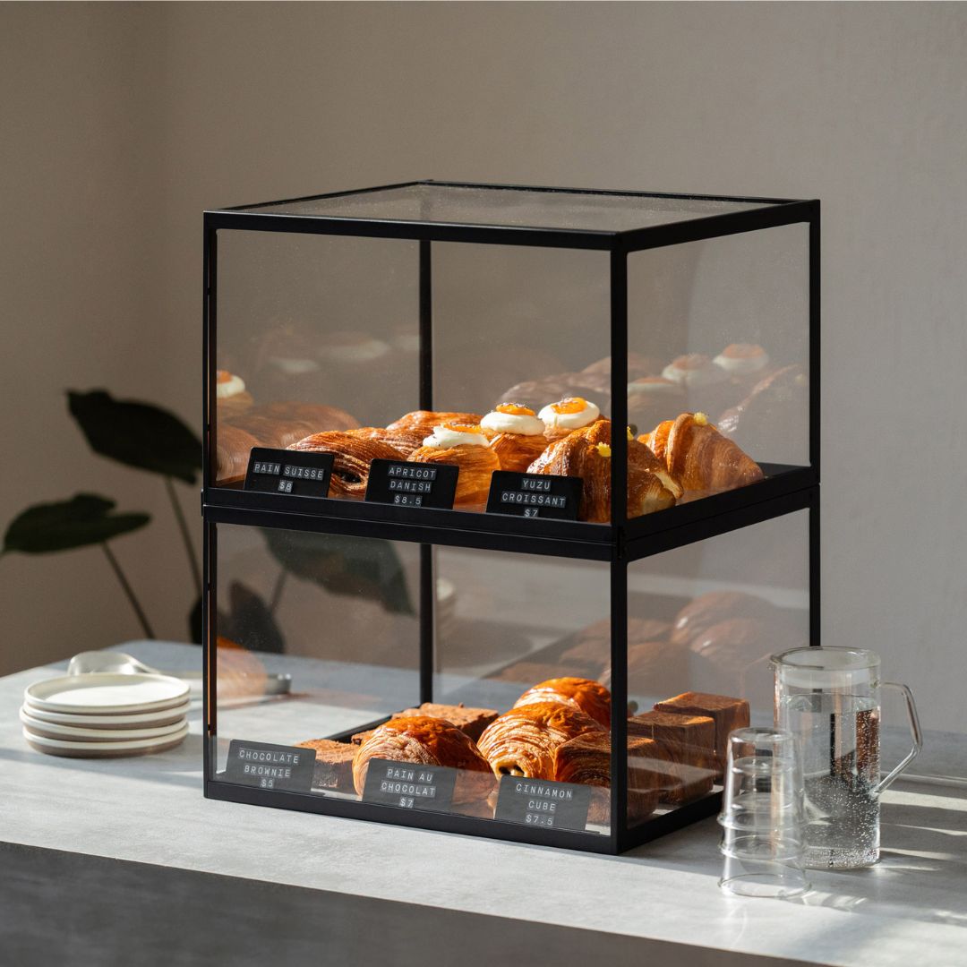 Two stacked bakery display case cabinets demonstrating multiple tiers showcasing fresh pastries