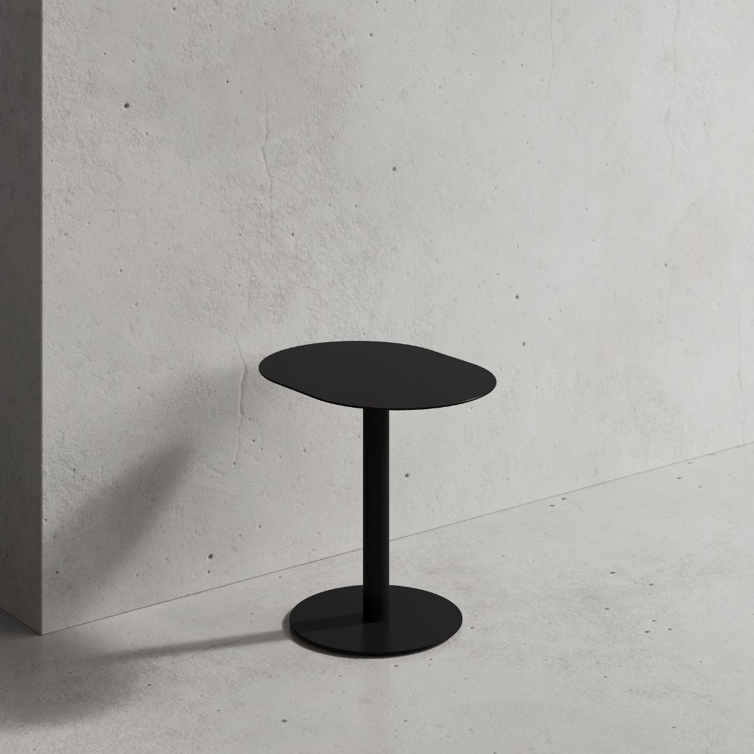 black outdoors cafe table on front of coffee shop wall