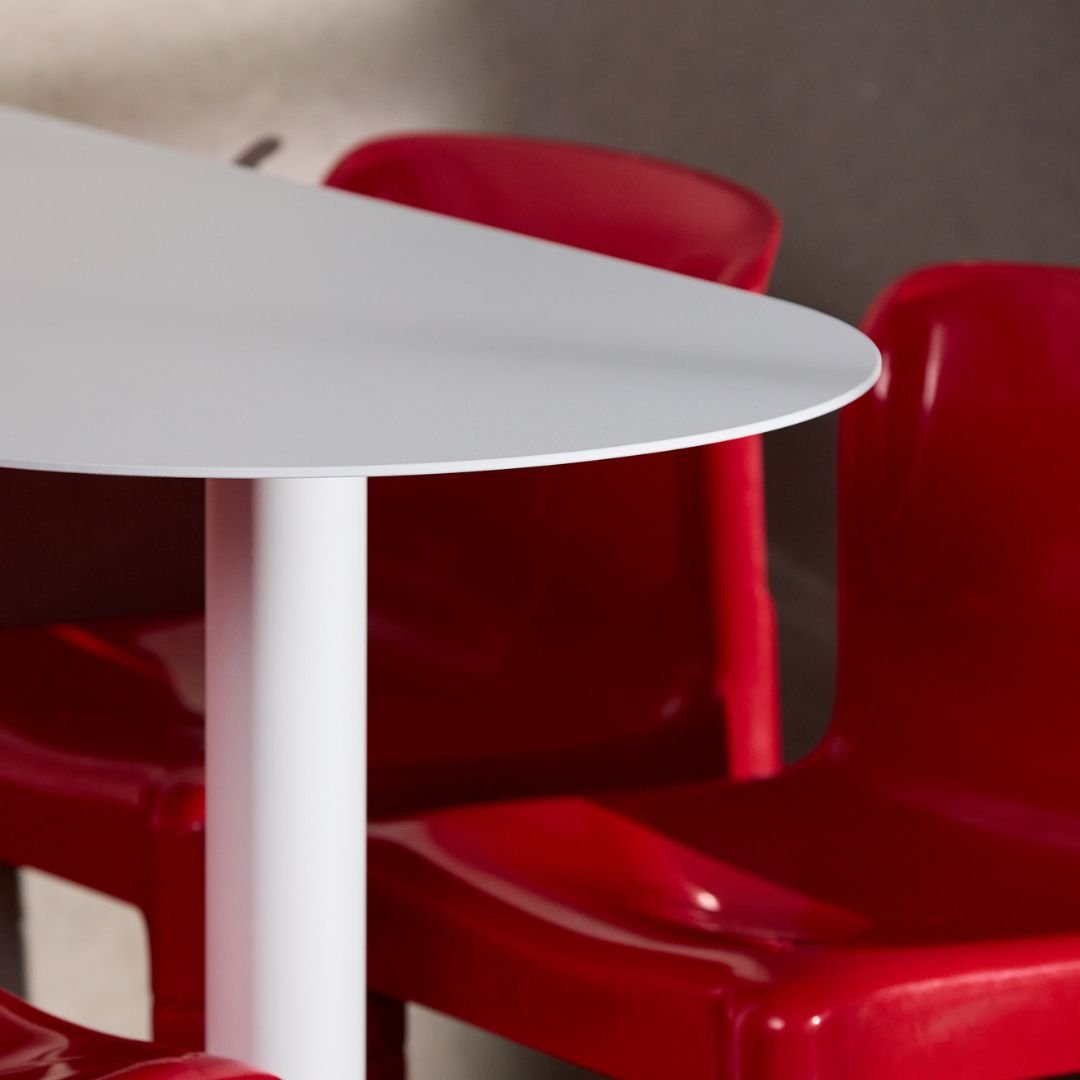 Close-up of white aluminum booth cafe table top showing curve of restaurant table