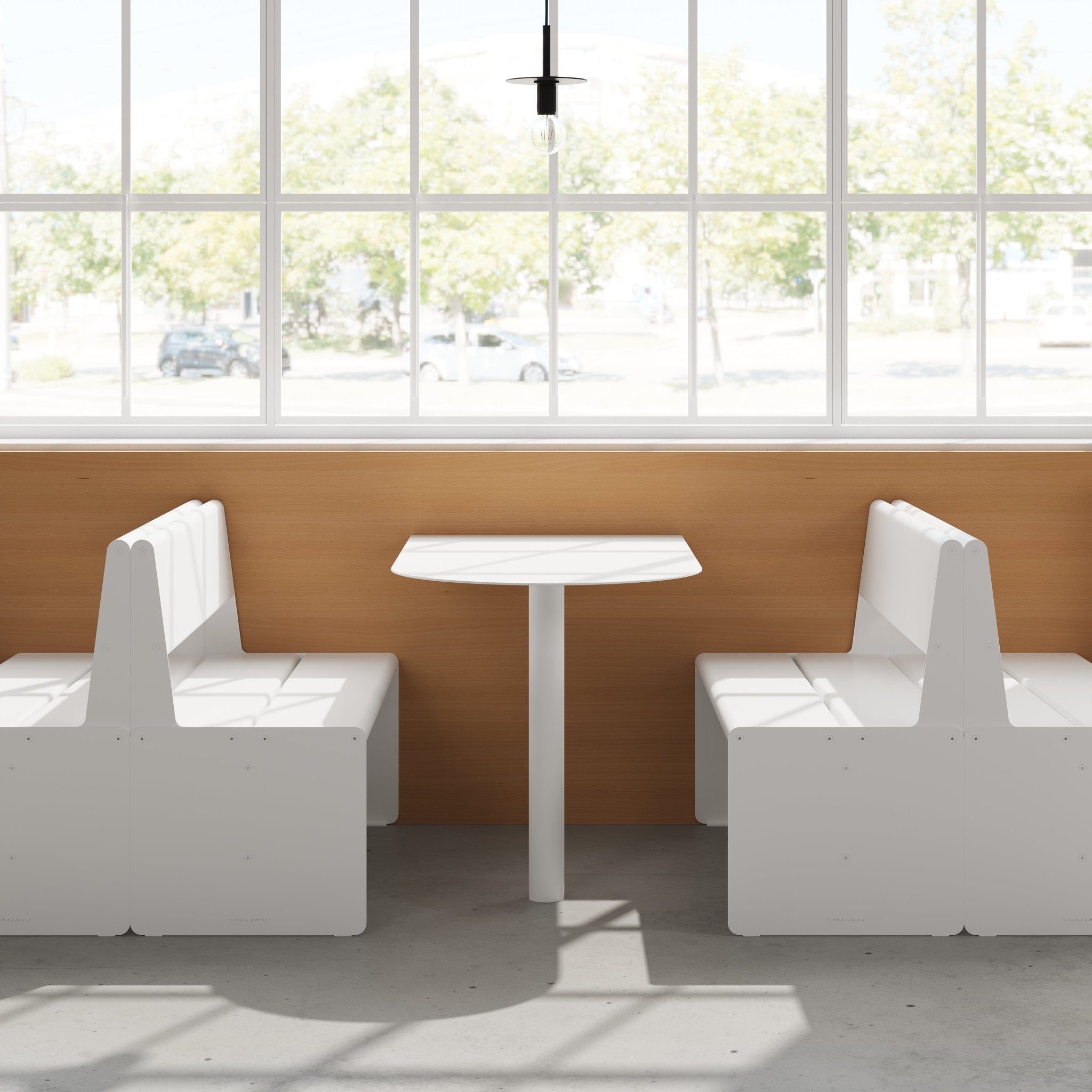 two white booth seats facing each other with the booth table in between