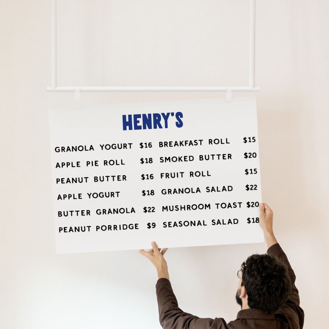 white ceiling menu board face panel being lifted by person onto hooks