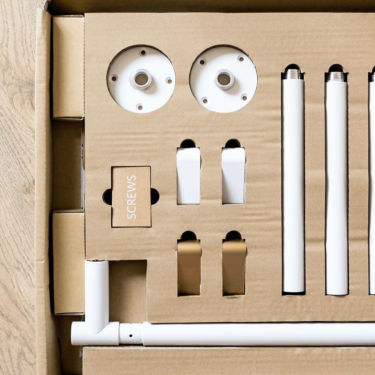 close up of packaging and components included in ceiling menu board