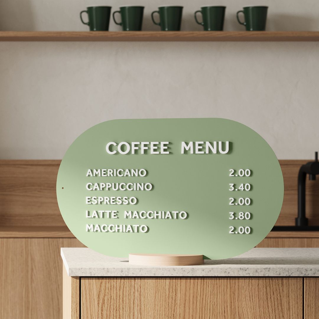 sage green curve tabletop menu display with white magnet letters on a countertop
