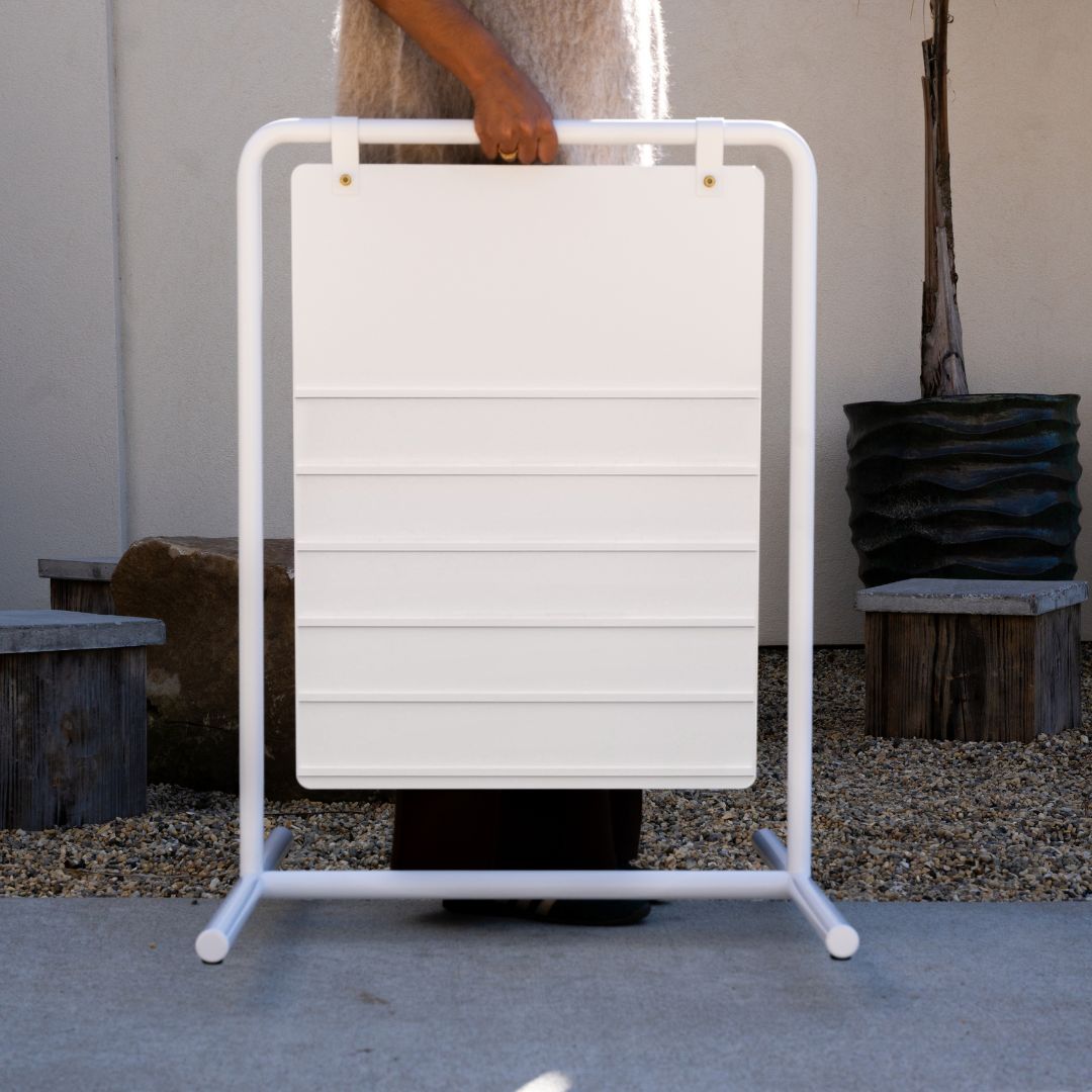 close up of person carrying a blank white letter swing sandwich board sign