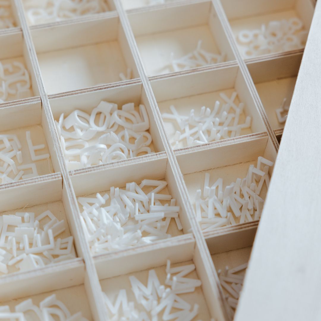 a photo of the storage box holding the felt board extra letters in their compartments