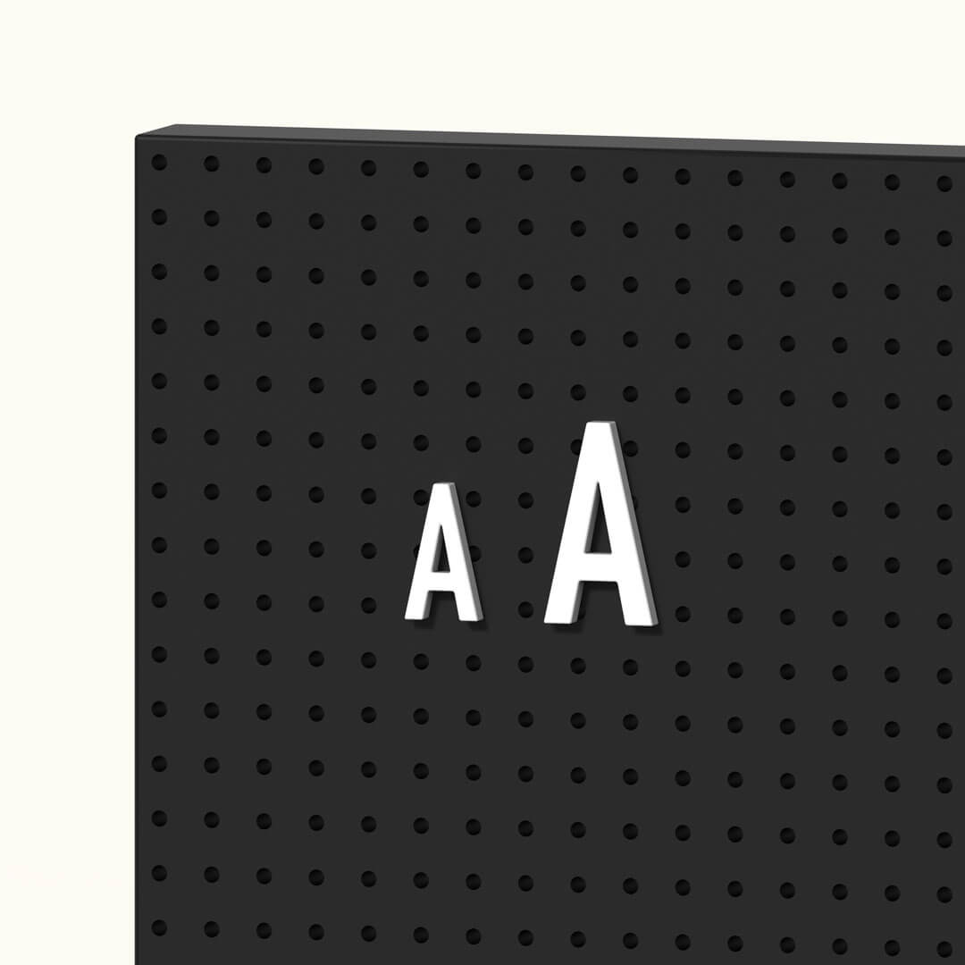 white peg letters in a black metal menu display