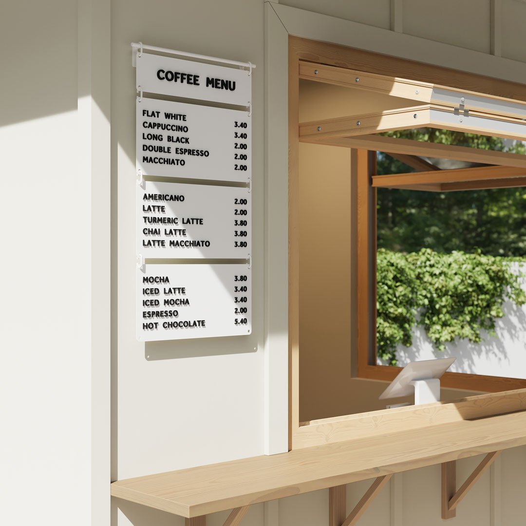 white hanging cafe menu installed outside a coffee kiosk