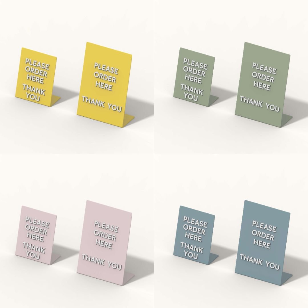 a grid of four photos of the two sizes of table talker counter sign displays but each in diferent colour to show colourways
