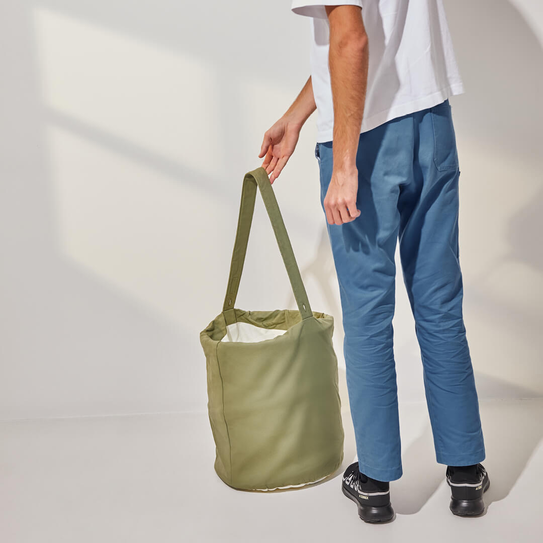 person standing beside the laundry hamper to show scale