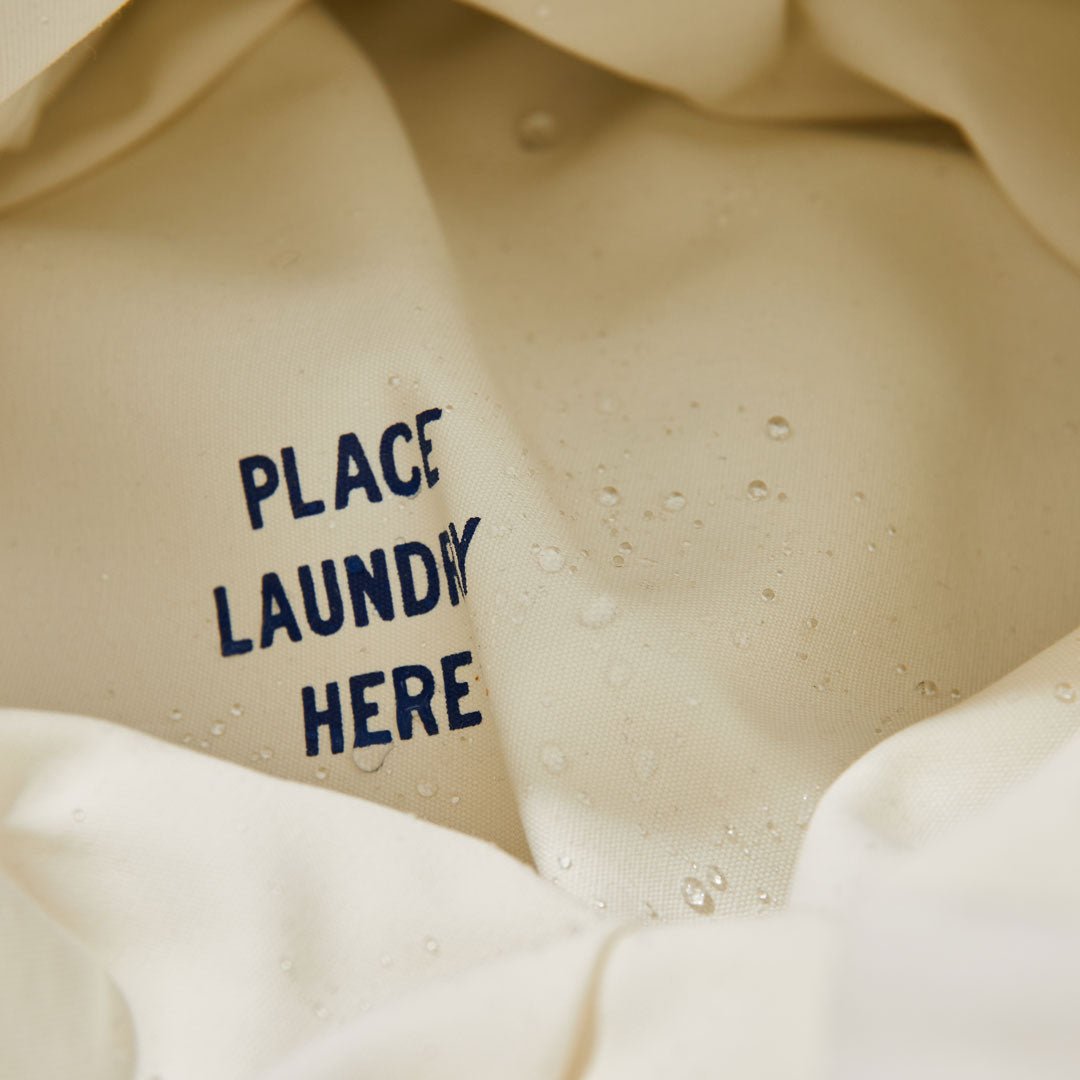 "place laundry here" printed inside the bottom of the laundry basket hamper