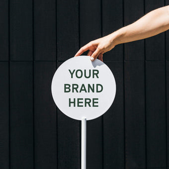 face panel of freestanding metal advertising circle sign in white with logo