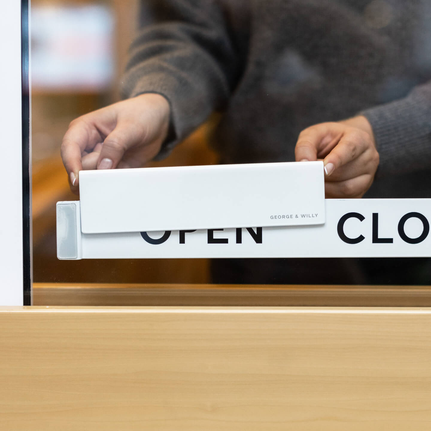 Hand sliding aluminum Open and Close sign on shop door bracket from closed to open