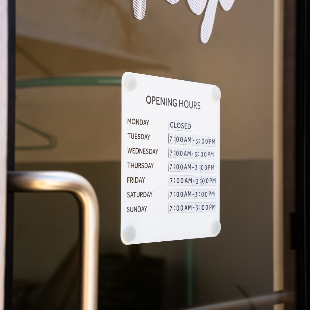 Opening Hours Advertising Sign for window mounted on shopfront glass door with handle