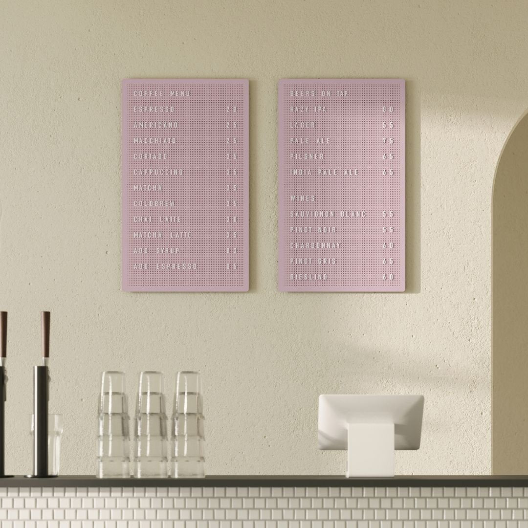 Pink peg letter board with café menu, attached to wall in neutral cafe interior