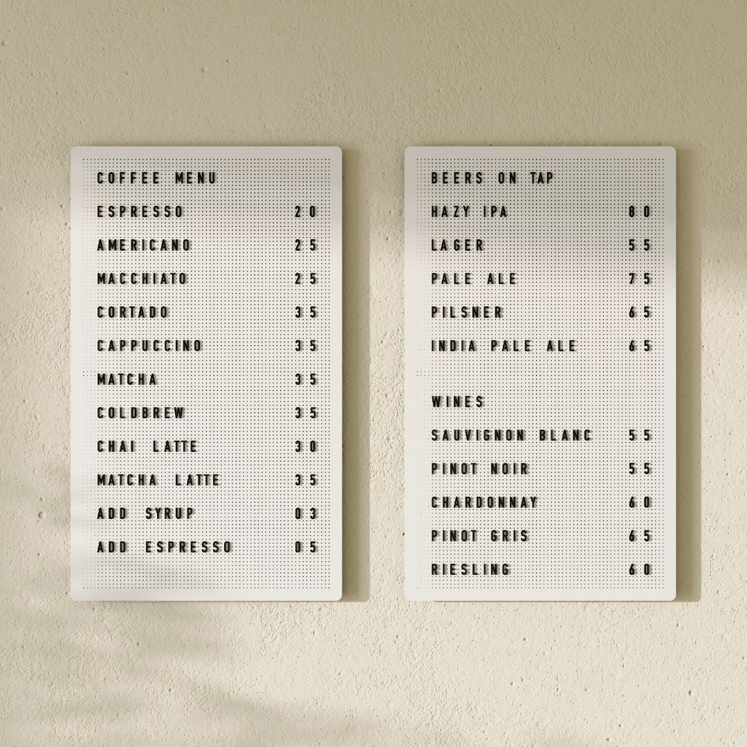 Pair of white peg letter boards displaying café menu, mounted on wall