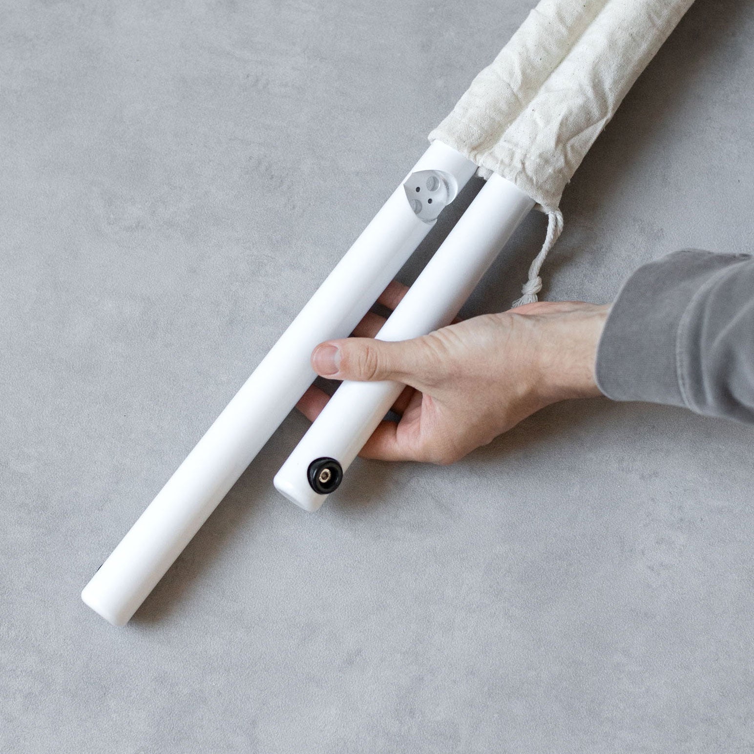 photo of hand holding the unassembled poster sidewalk pavement sign rails to show detail