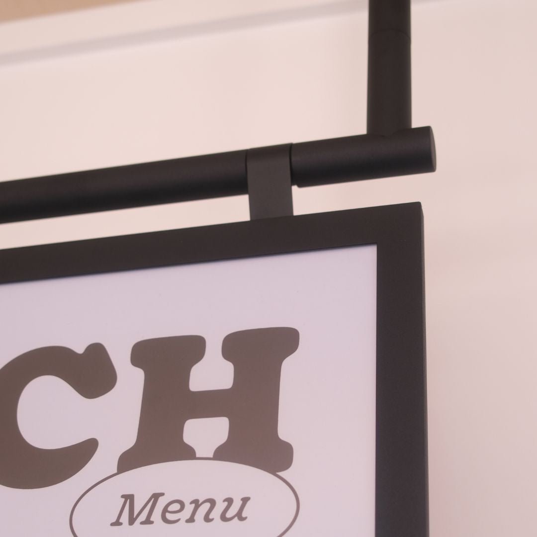 close up of poster hanging menu board hooks and joinery