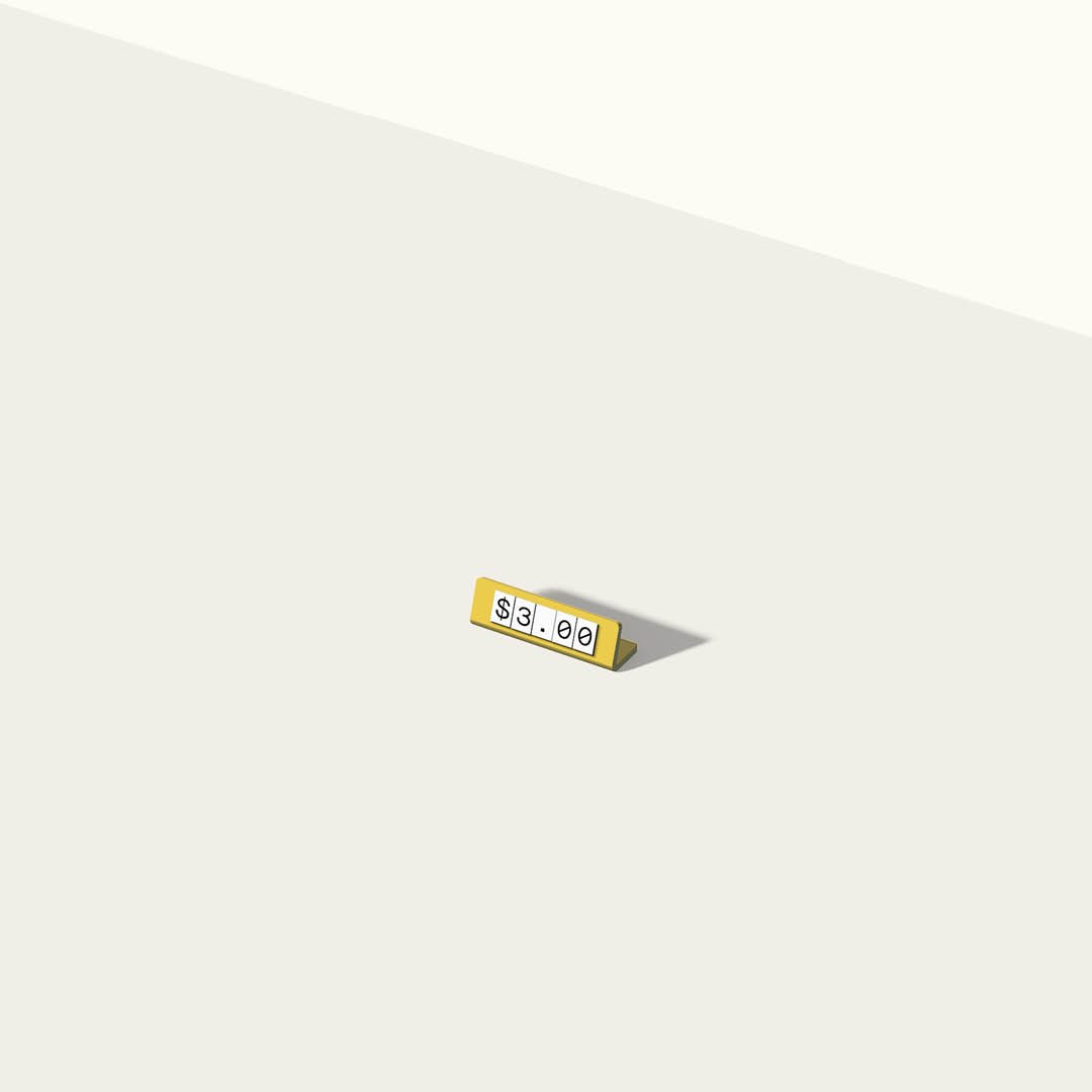 single pricing sign in a studio in pink