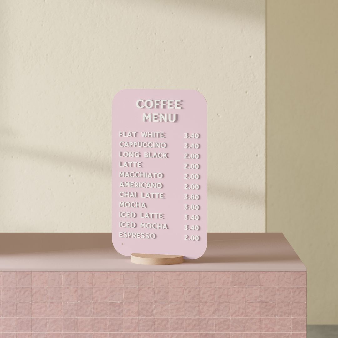 pink rectangle tabletop sign on pink countertop