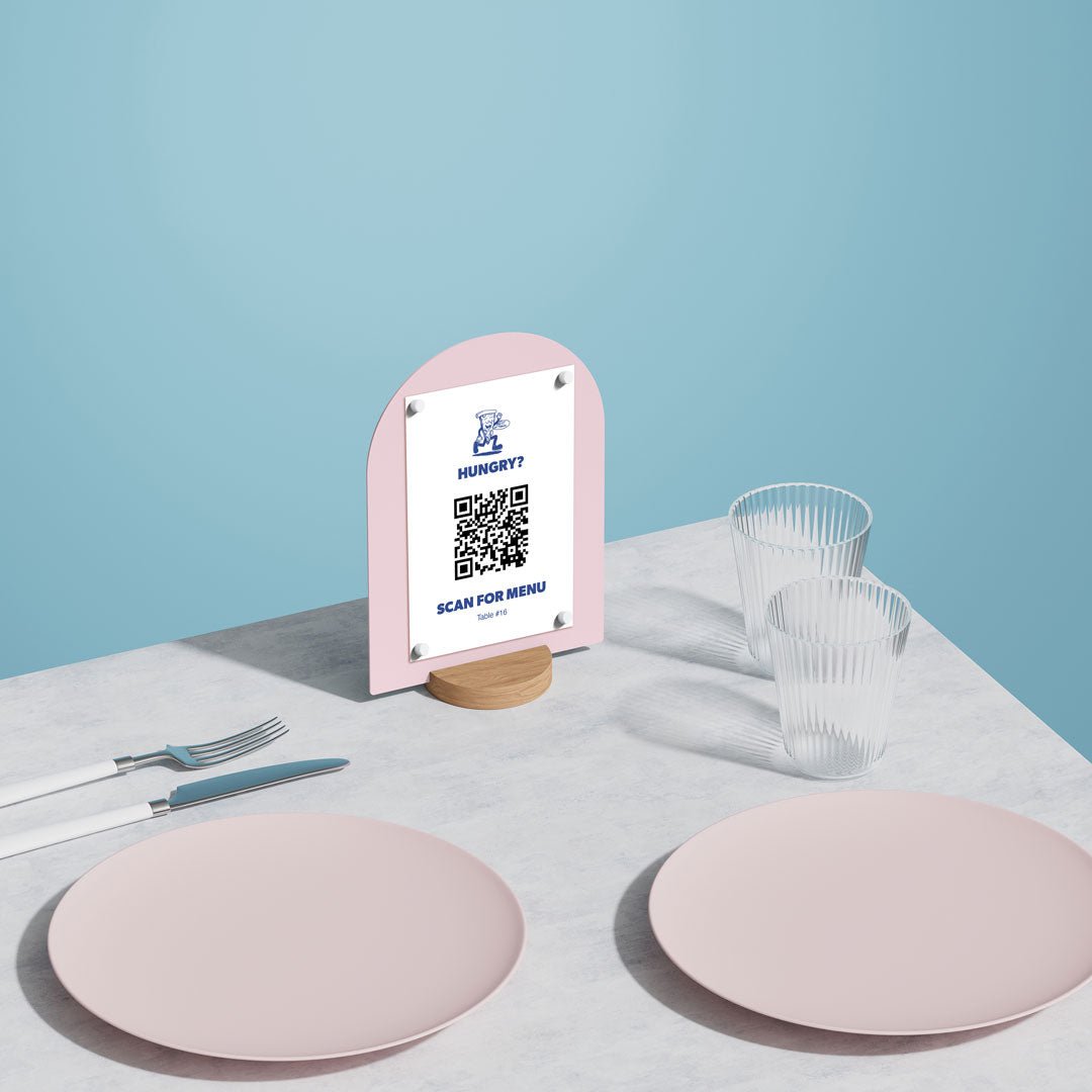 pink round table talker on a table beside two pink plates