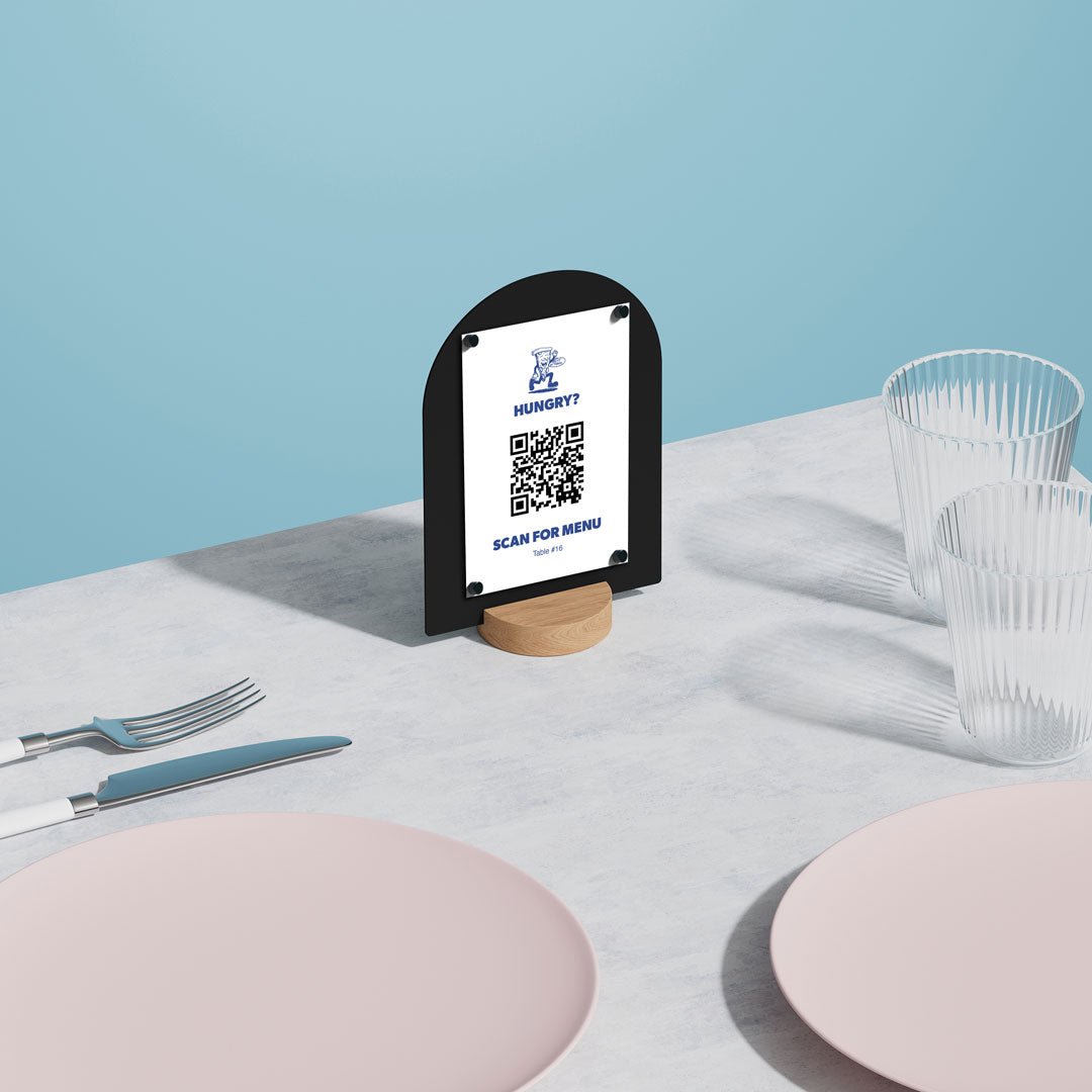 black round table talker on a table with QR code attached