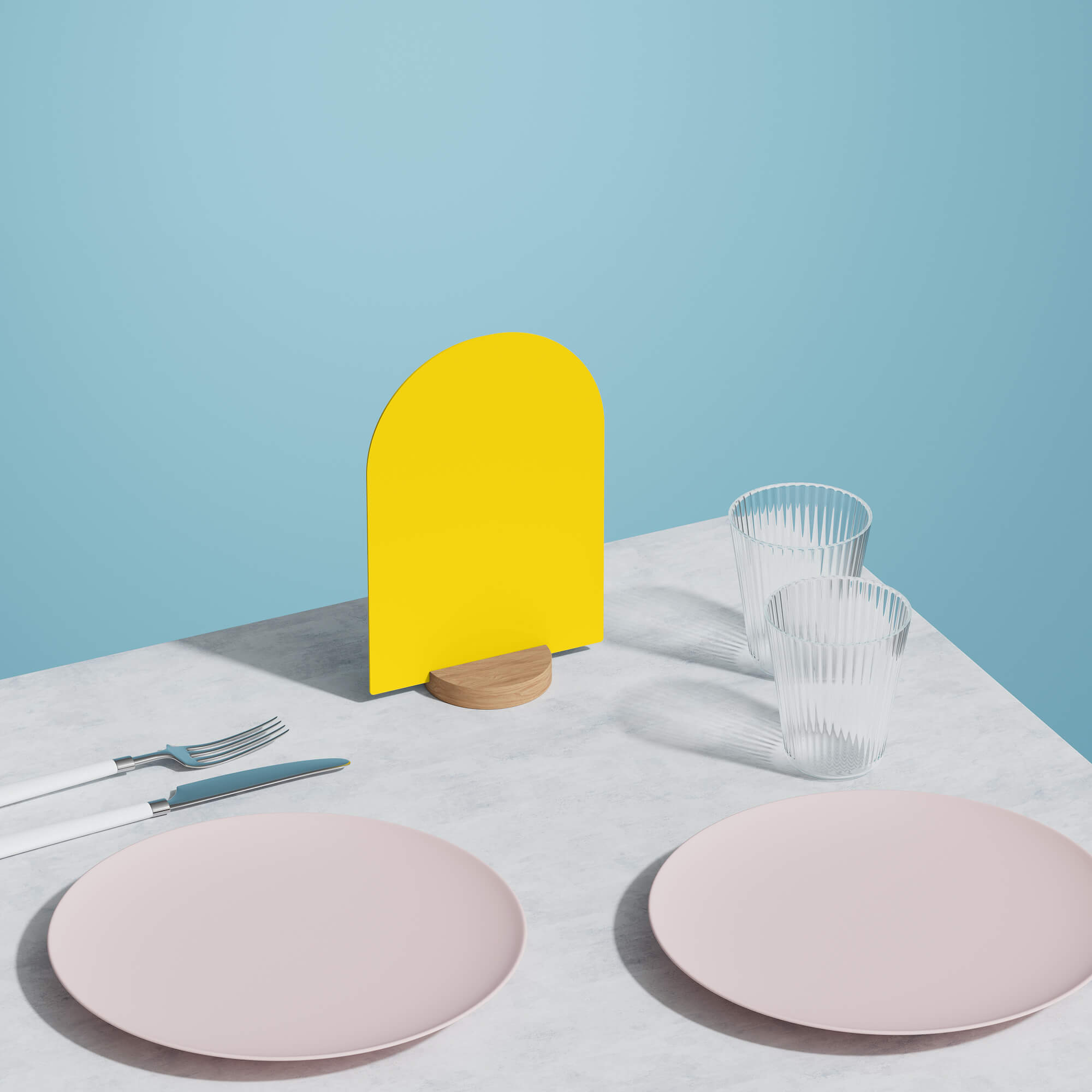 blank yellow table talker on a table beside two pink plates