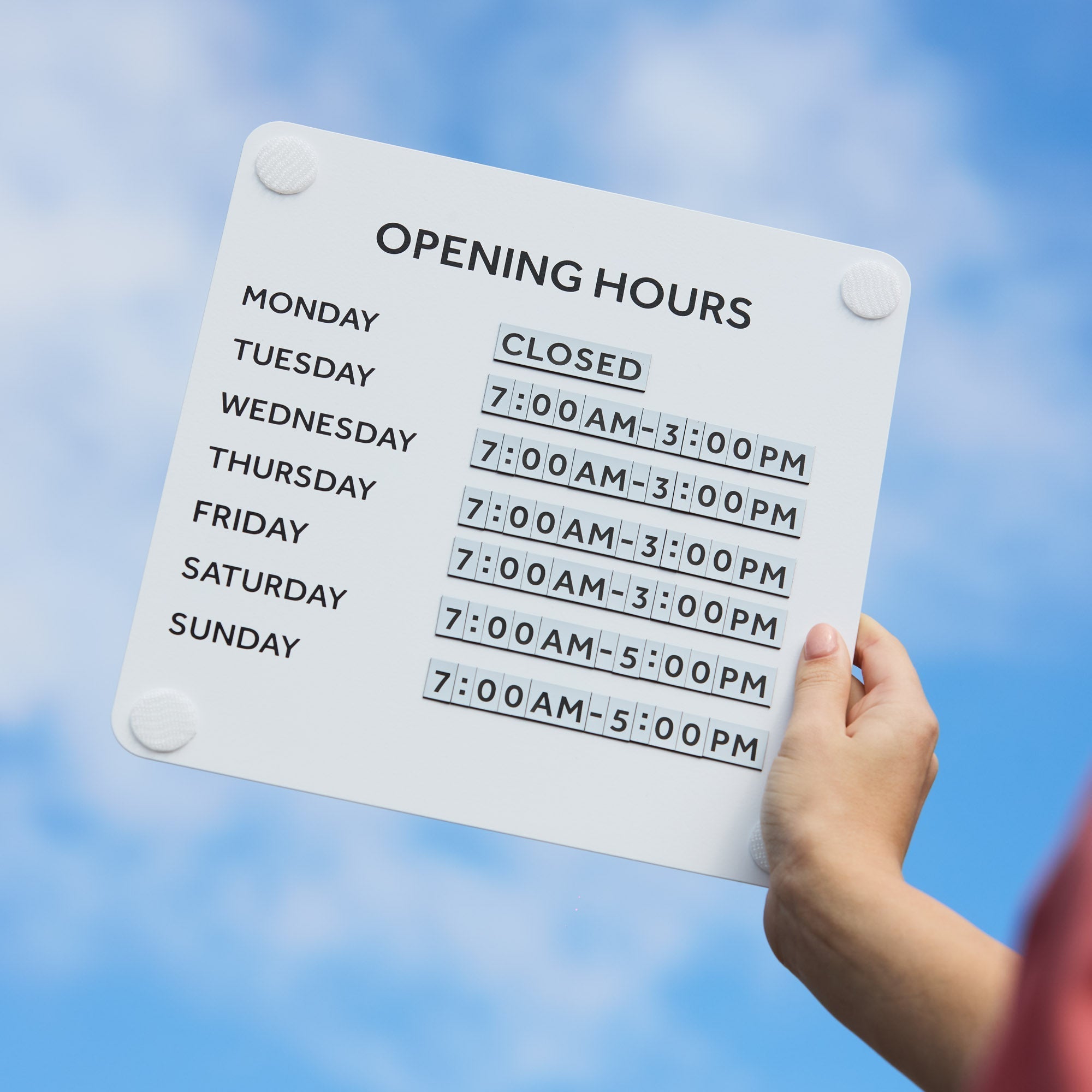 Open business Hours Sign held up to clear blue sky, highlighting sleek steel design and magnetic digits
