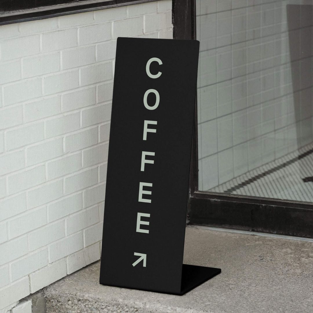 black metal welcome business company sign at an entranceway