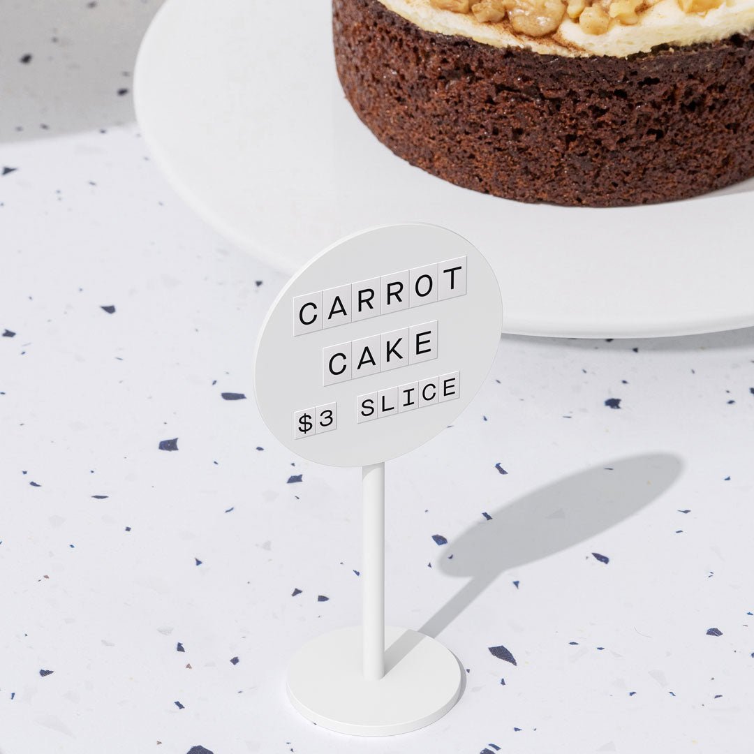 white standing circle magnetic retail pricing sign with white magnet letters showing pastry pricing
