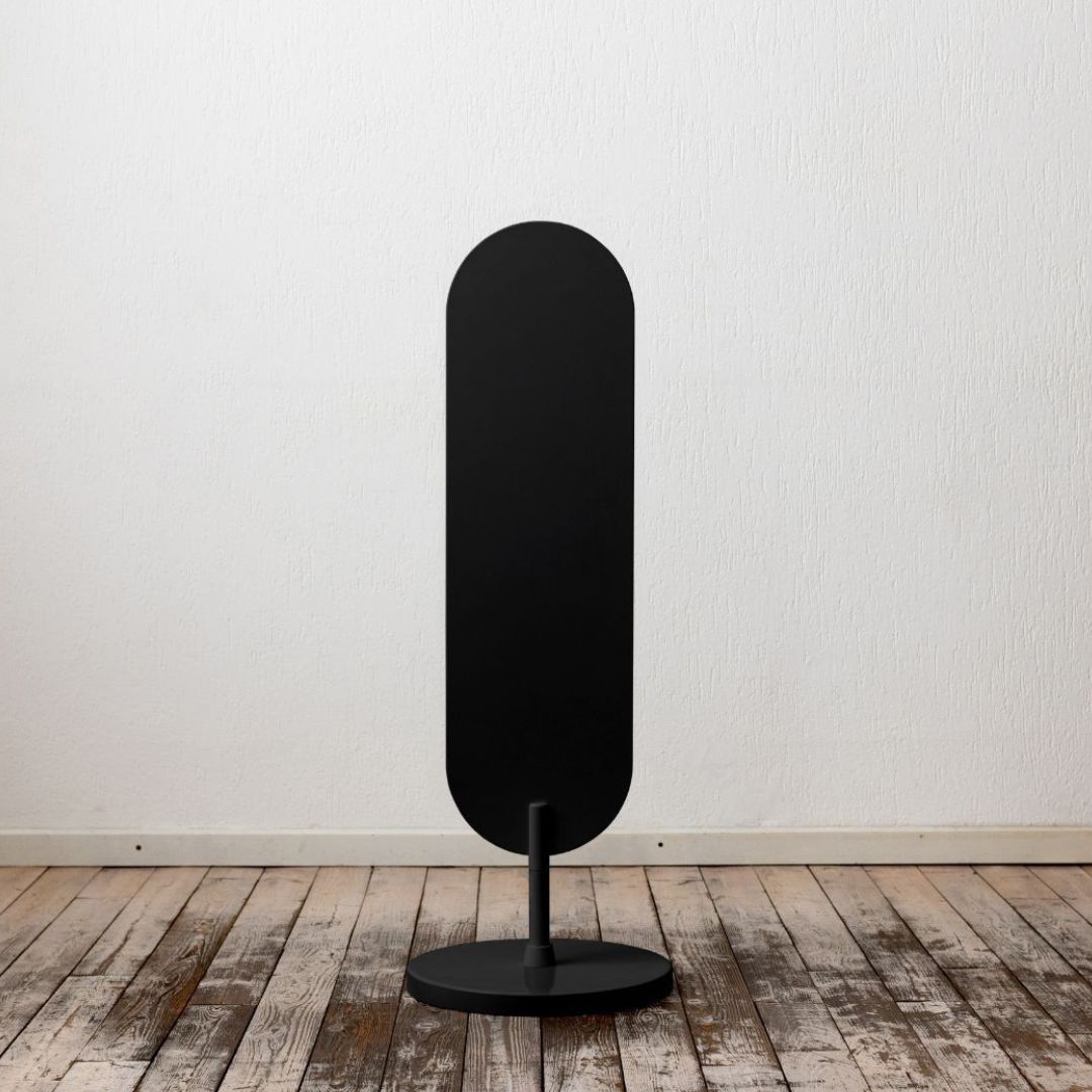 plain black large standing curve sign inside a studio