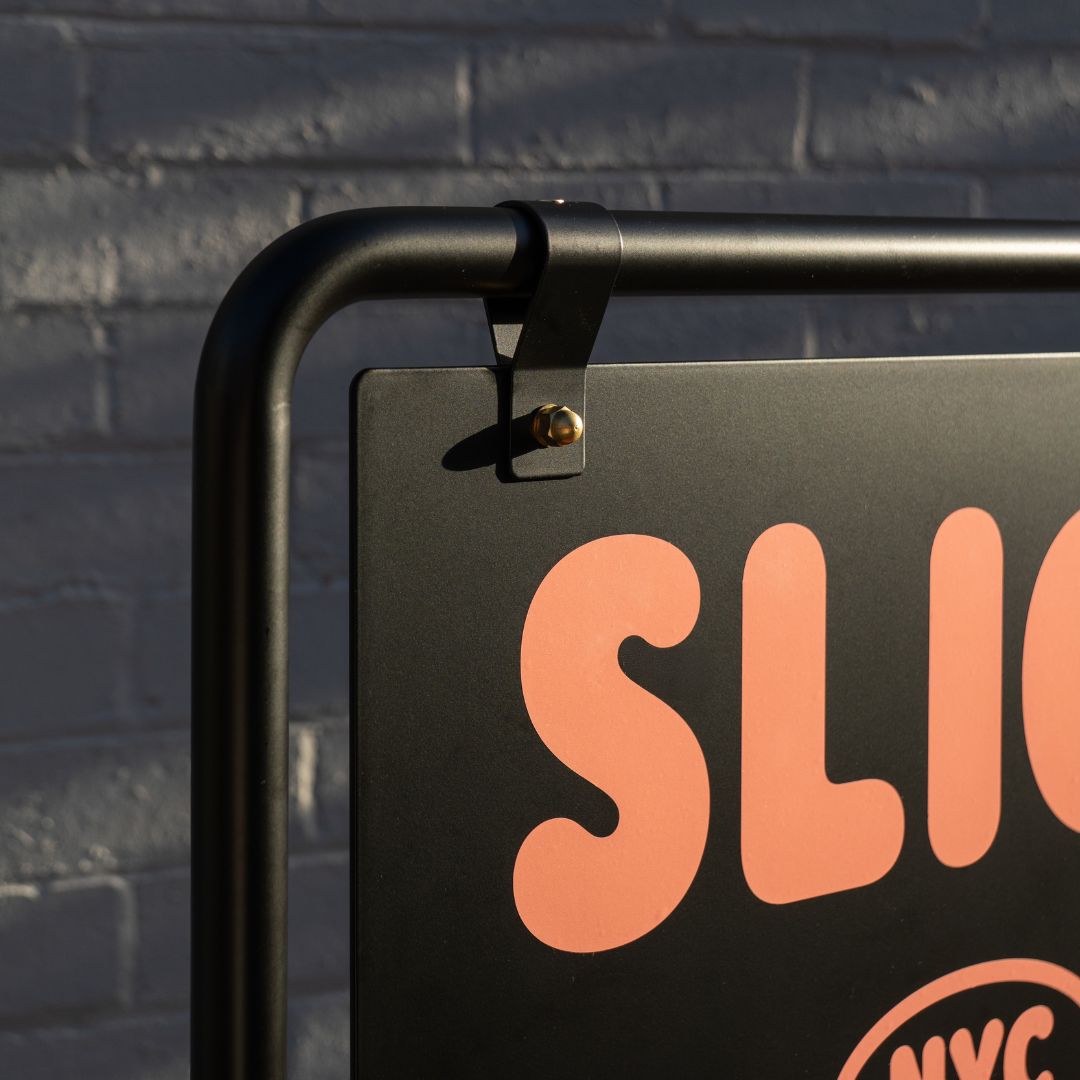 close up of bolt and joinery detail on black commercial swing sign