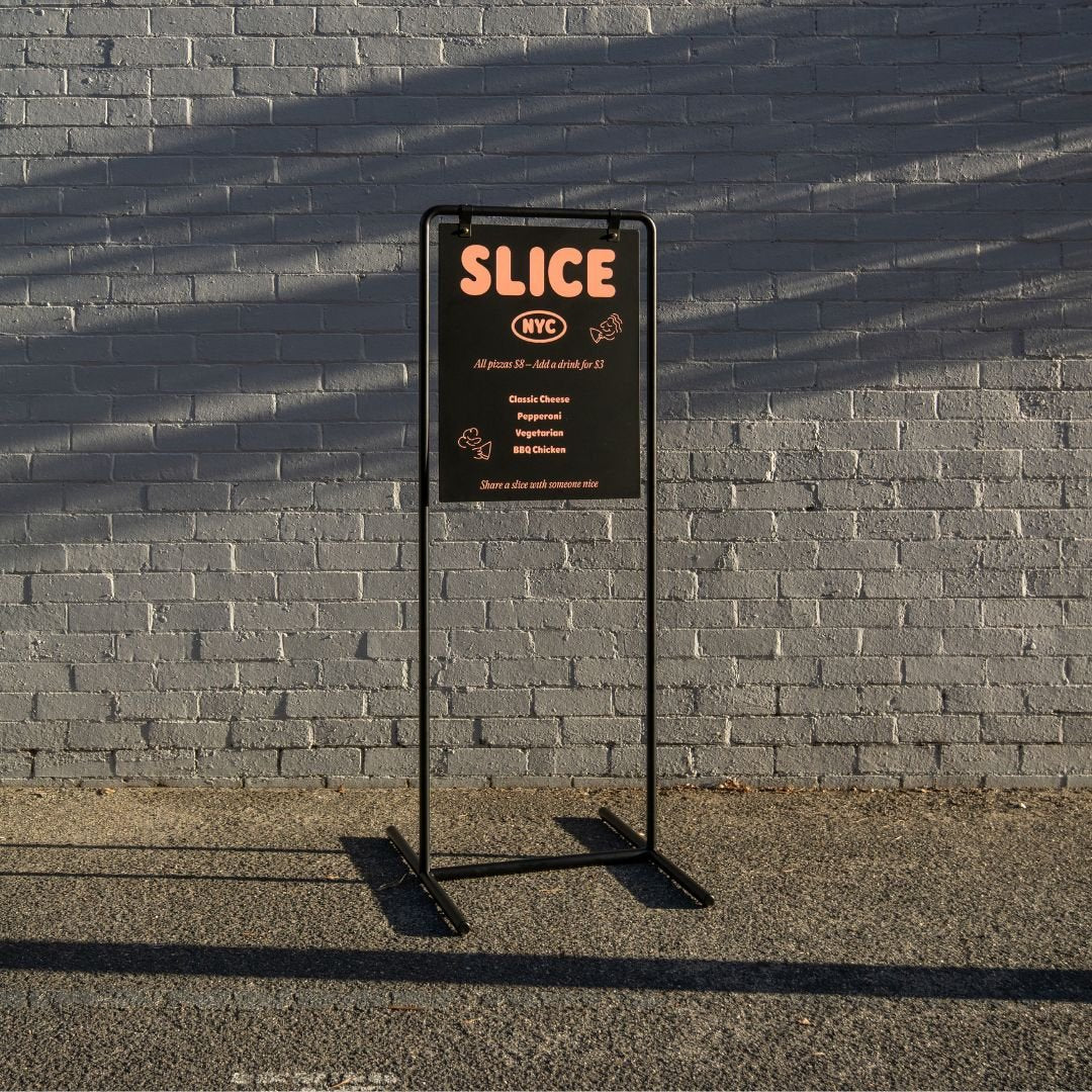 tall version of the pavement swing business sign at golden hour on a sidewalk