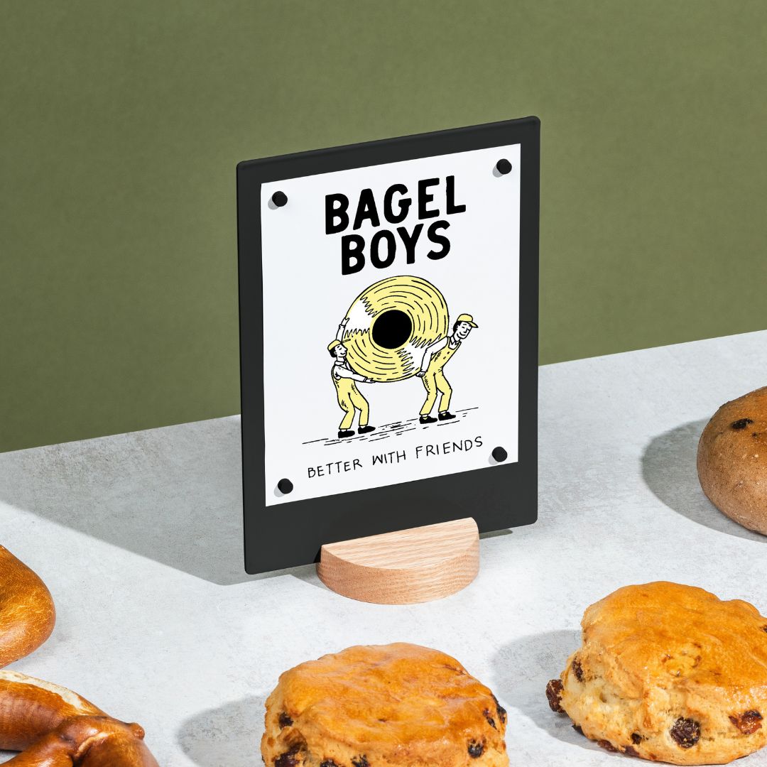 black table talker on a countertop surrounded by pastries
