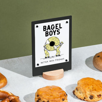 black table talker on a countertop surrounded by pastries