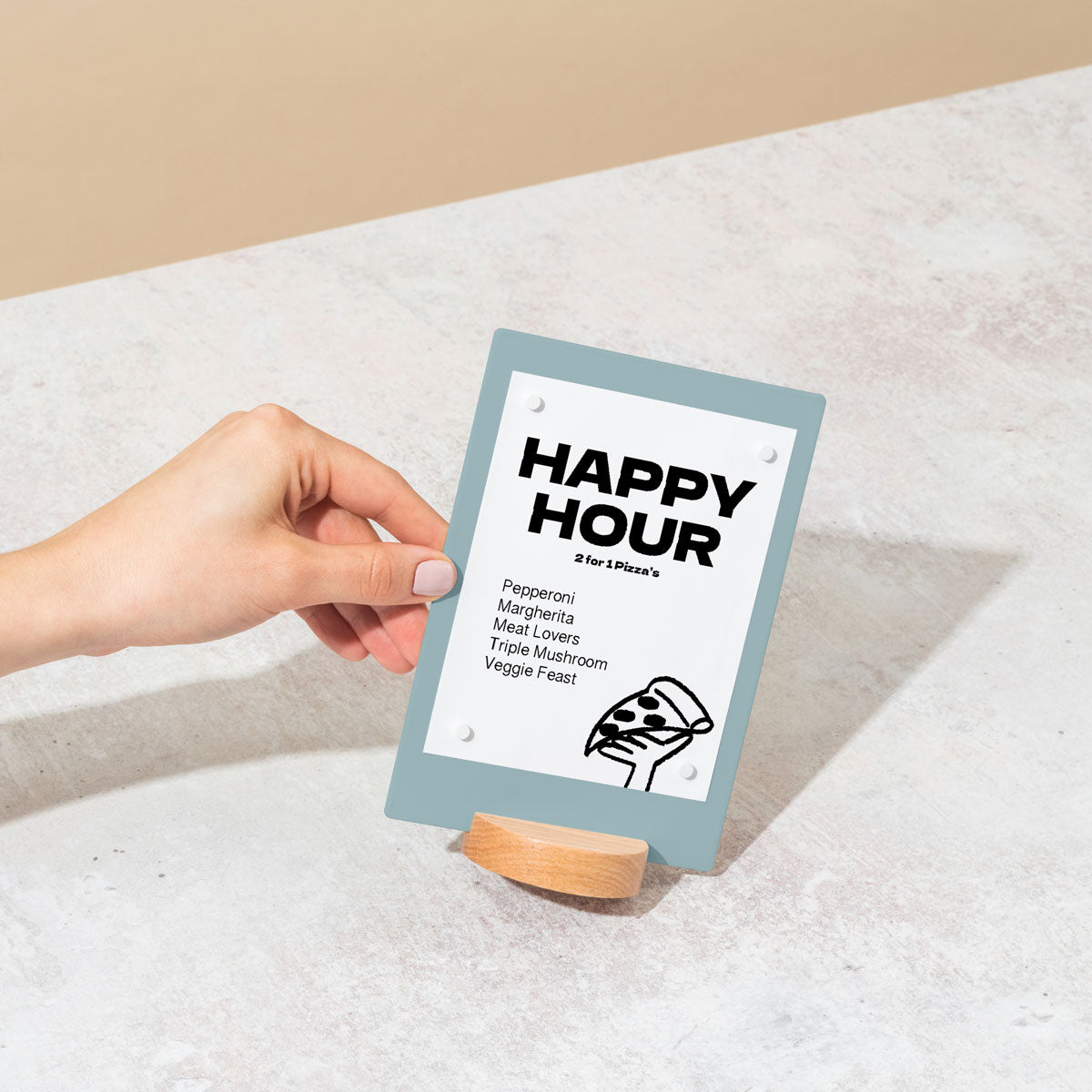 hand holding table talker in blue showing happy hour message