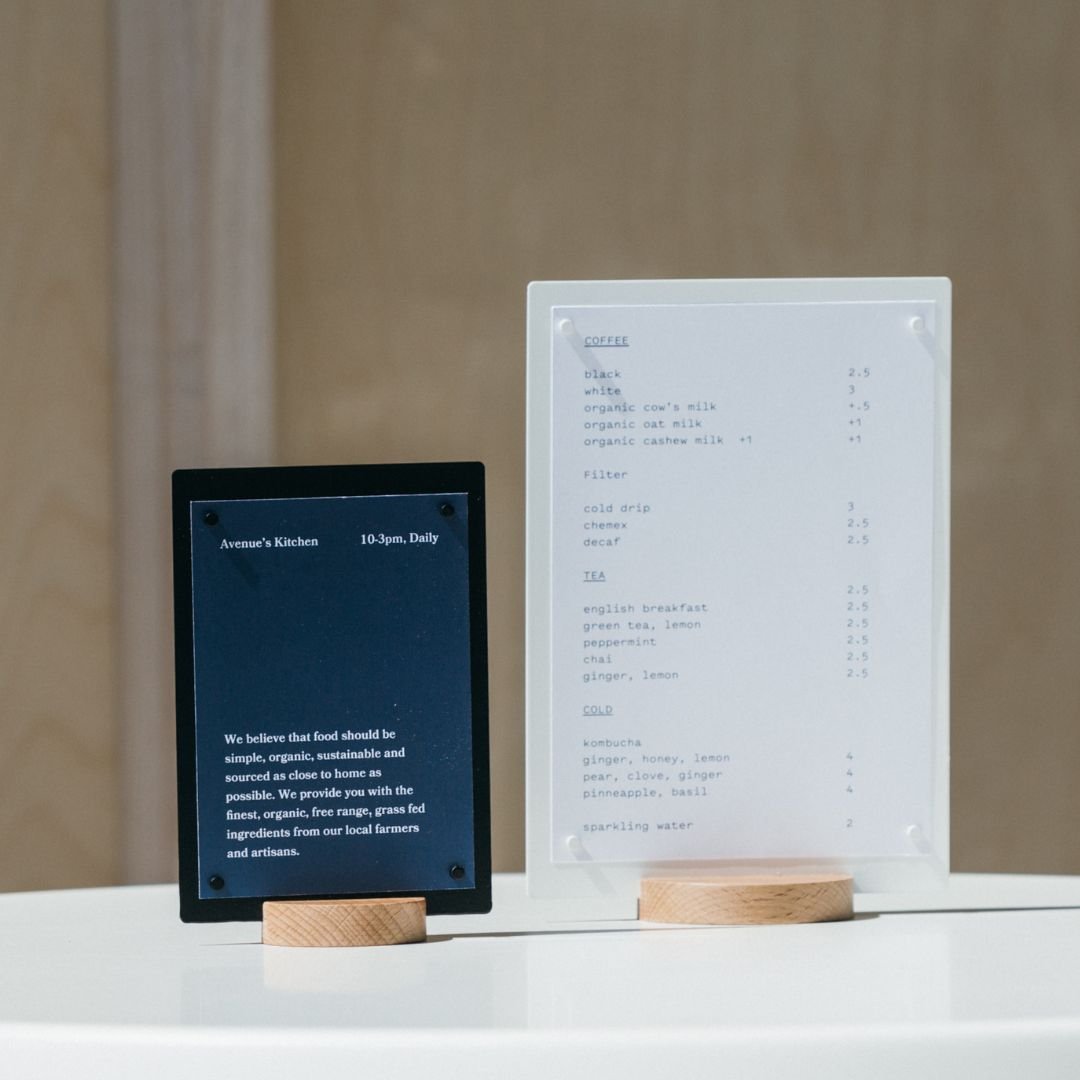 two table talkers side by side, one smaller-sized black beside a larger-sized white one