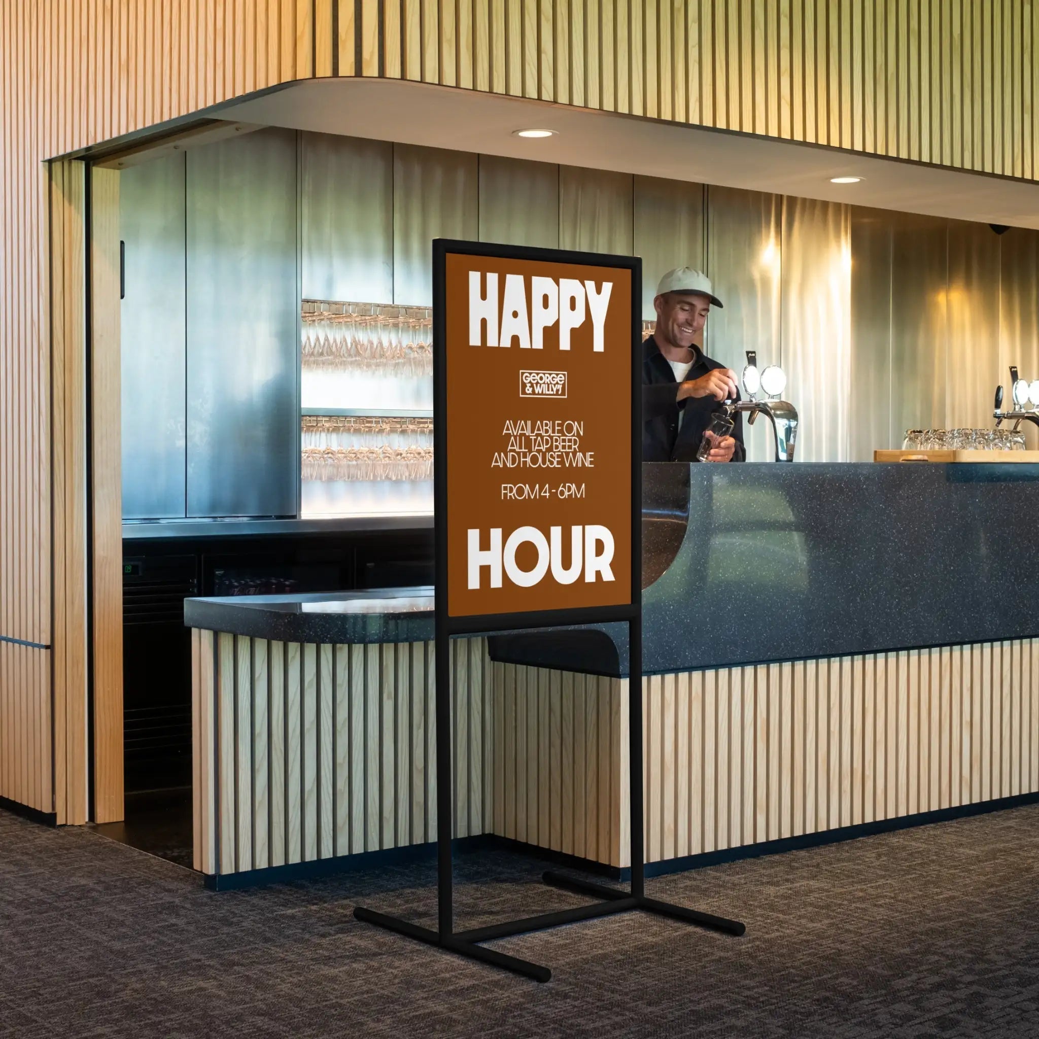 tall black poster sidewalk wayfinding sign inside a bar