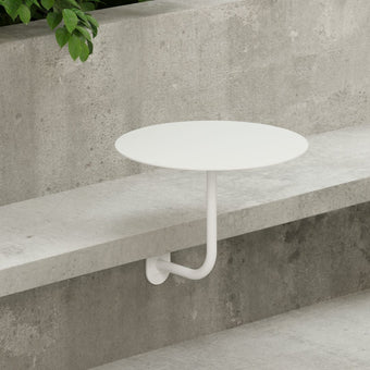 bistro style outdoor restaurant table attached to bench seat outside cafe