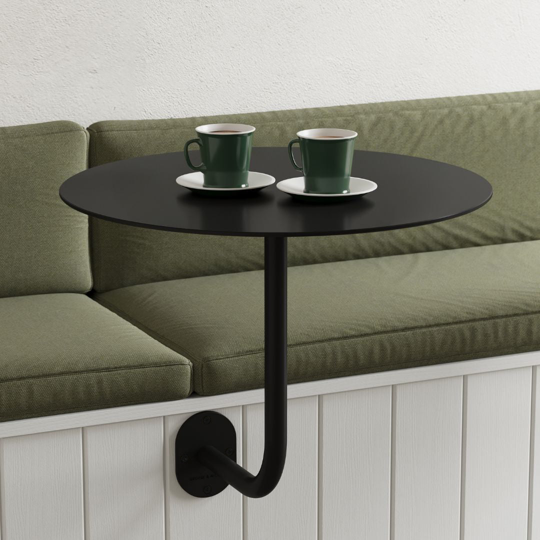 Wall Mounted Cafe Table in white with round top, attached to wall showing legroom and sleek design