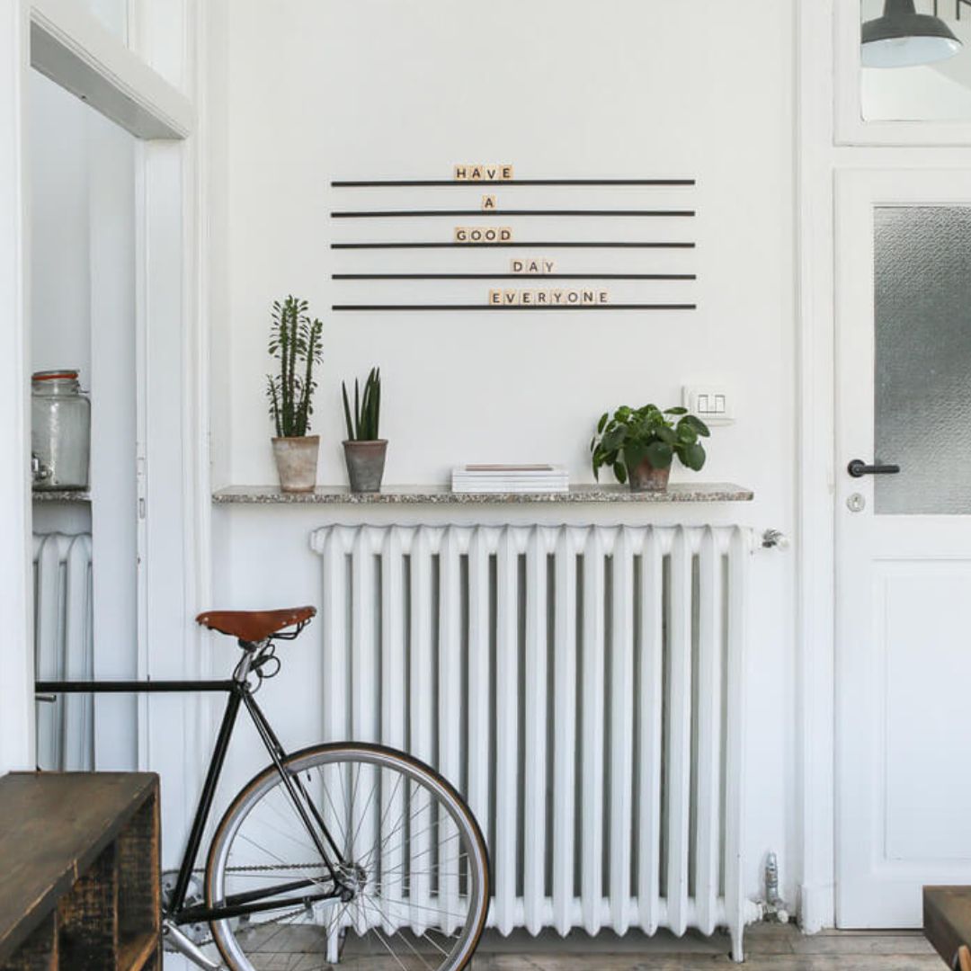 black wooden letter board rails with wooden letters installed behind counter with bike in front of counter