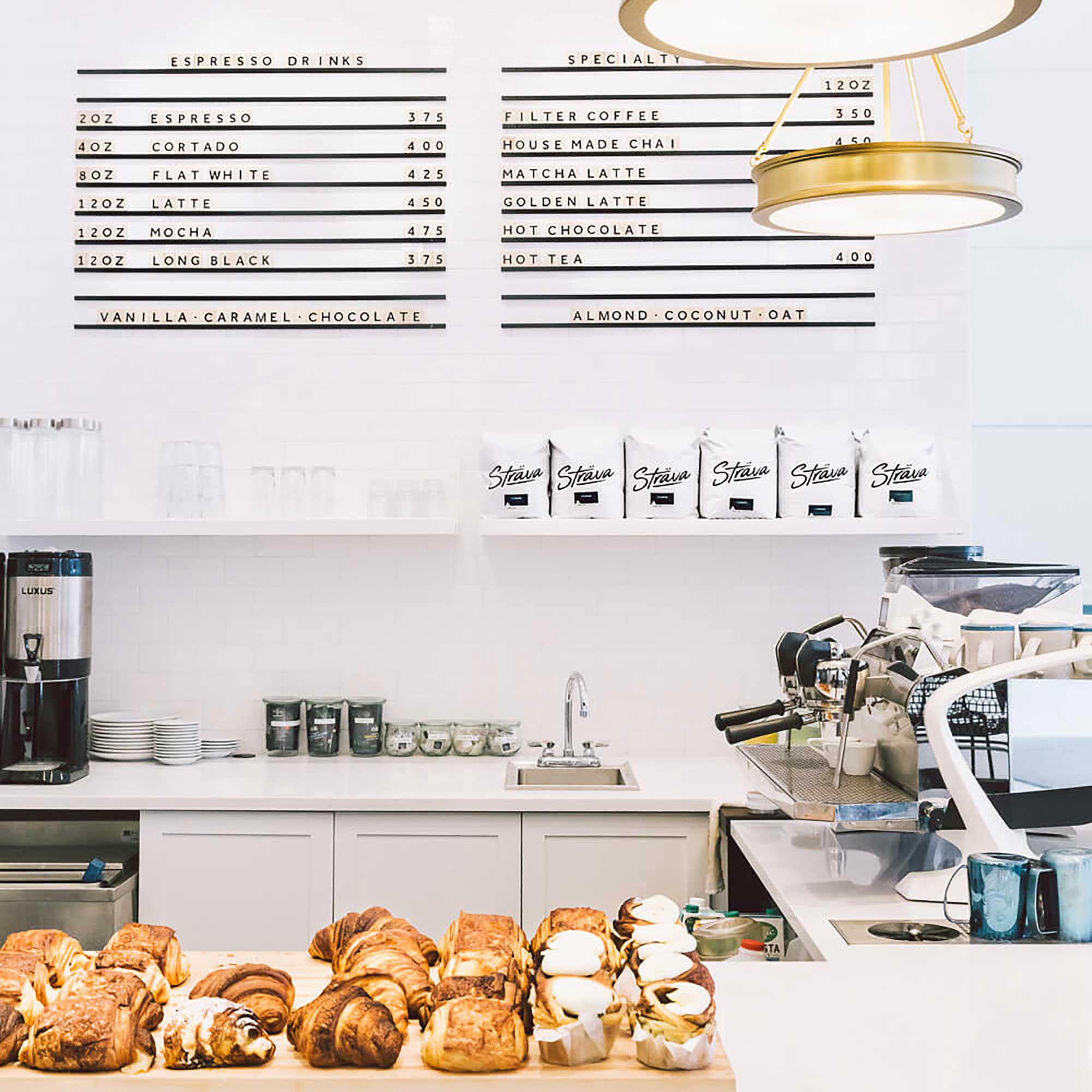 two black railed wooden letter boards installed side by side behind bakery counter