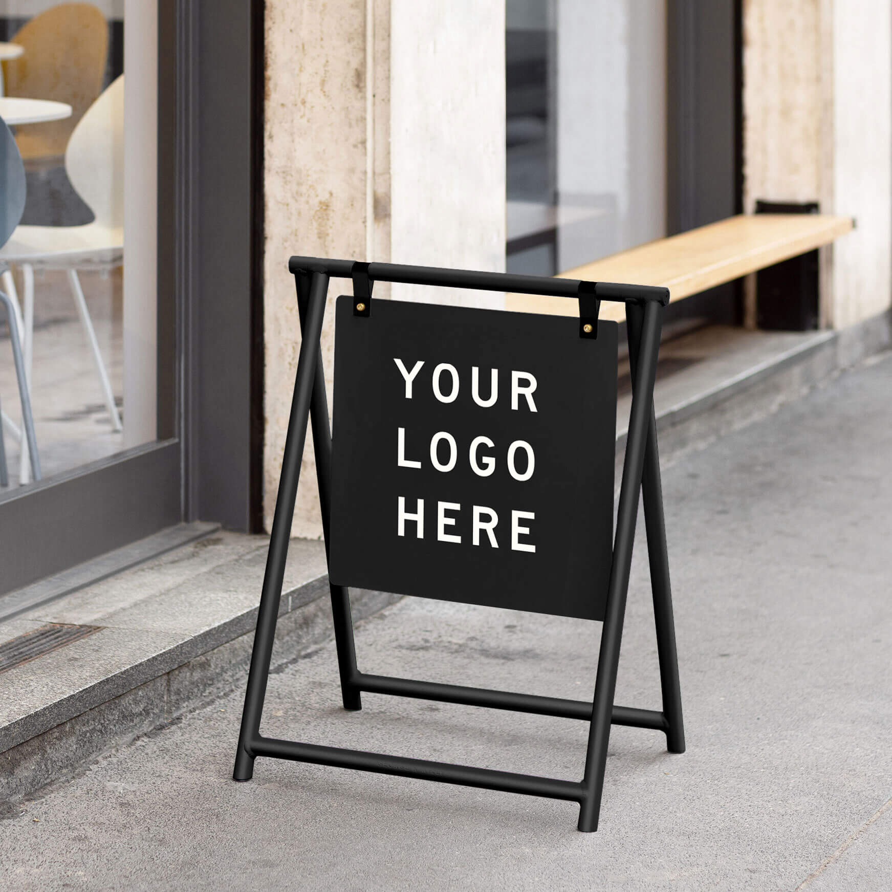 A Frame sandwich A board sign in black metal finish placed outside café entrance showcasing example text