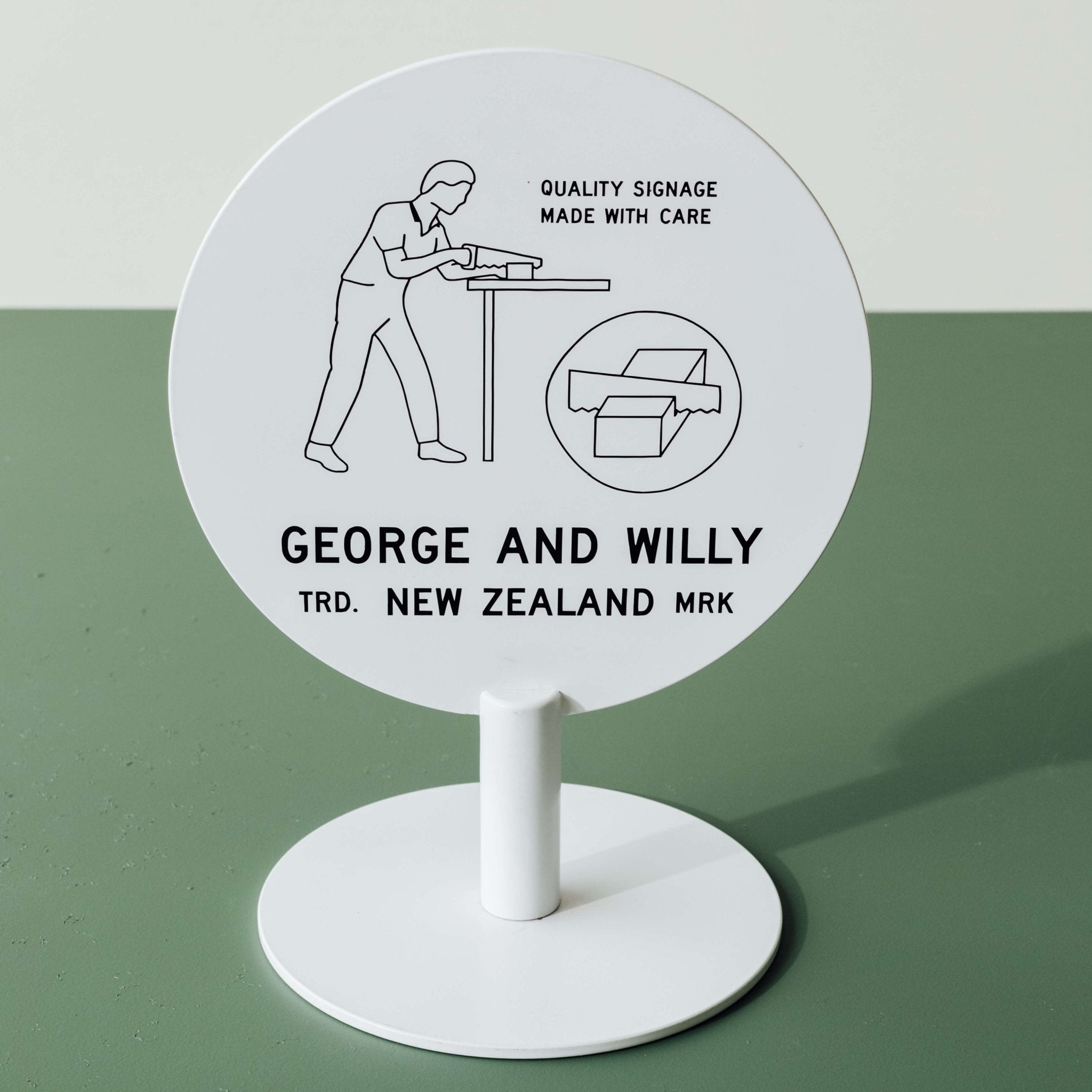 white circle sign standing upright on a green tabletop