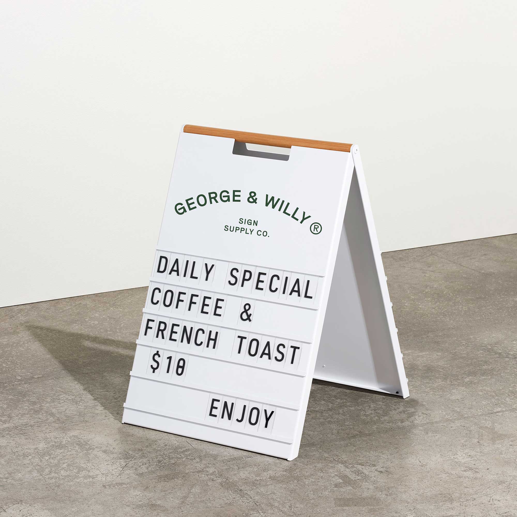 white letter pavement sign inside a studio with message displayed