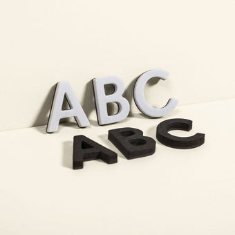 white and black magnet letters showing A B C