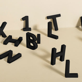 assortment of black magnet letters