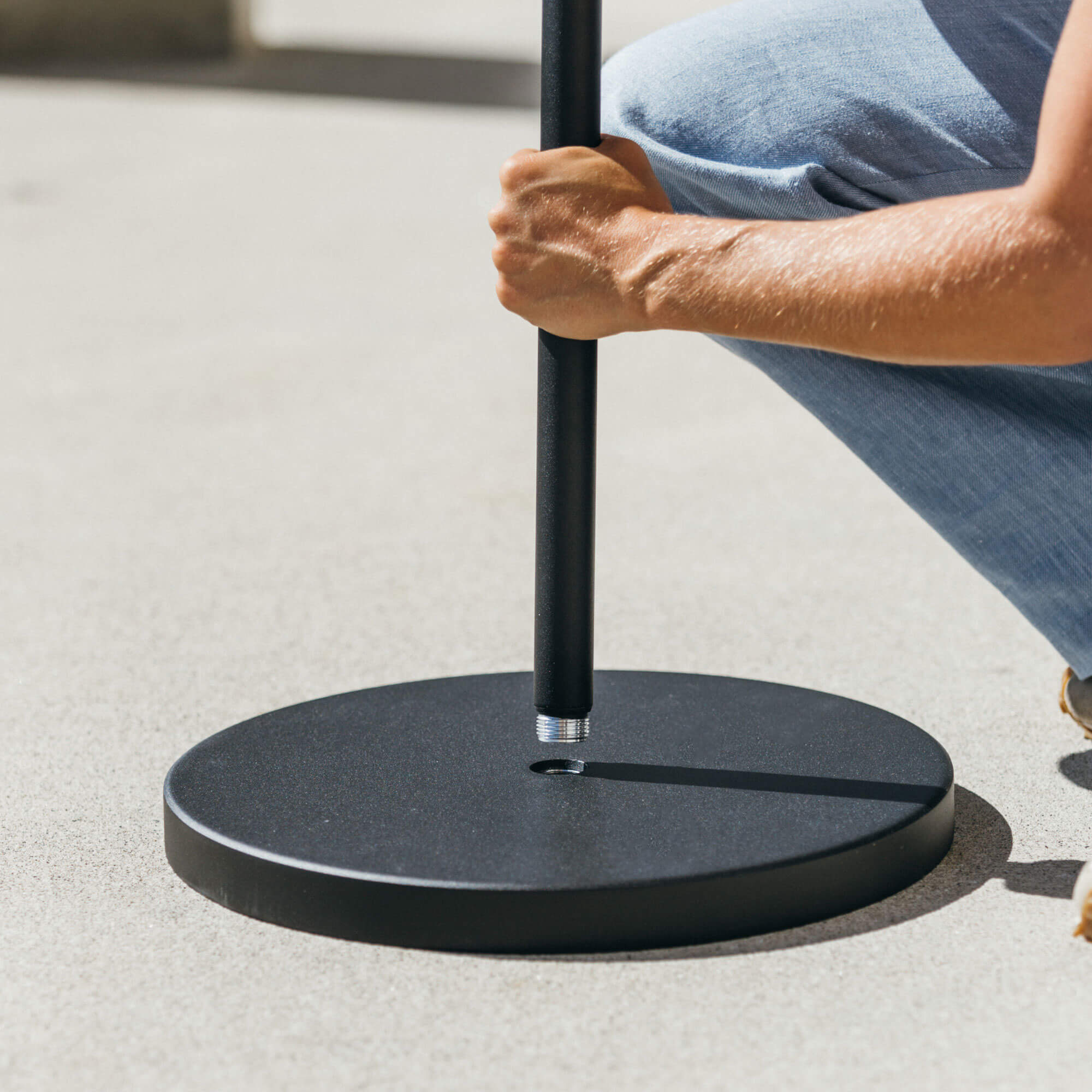 close up of black menu stand base with person screing in the pole
