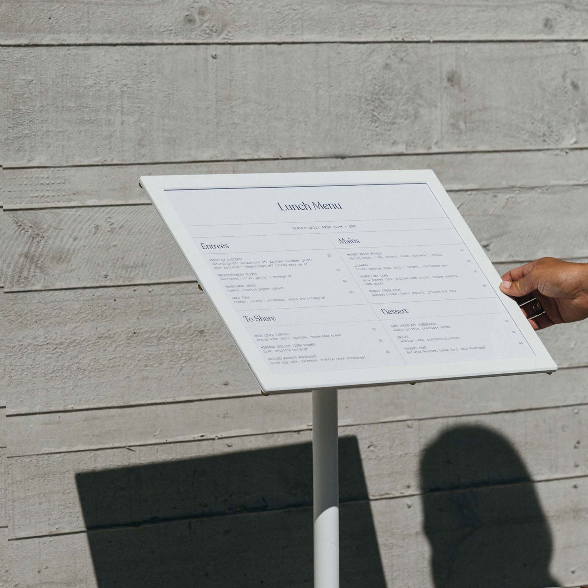 close up of white menu stand with menu displayed horizontally