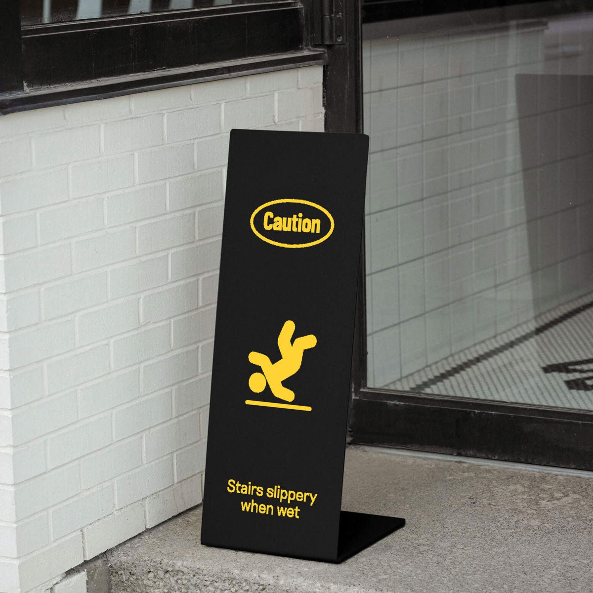 black welcome sign at a glass door entrance with yellow vinyl